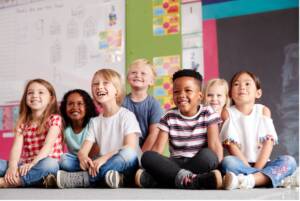 A group of children sitting on the floor, Back to School Dental Tips