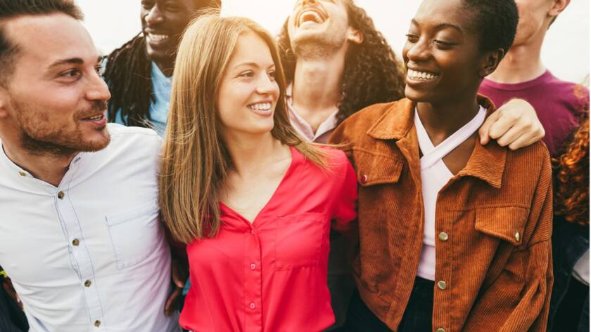 A group of people standing together, The Power of a Smile: How Positive Facial Expressions Can Enhance Your Health