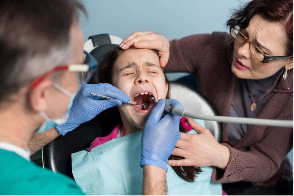 A person getting her teeth checked, Dental Sedation for Children